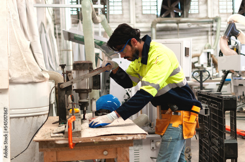 Carpenter or engineer working on woodworking machines in the wood factory, processes wooden products to produce furniture. crafting, skillful, factory process,wooden product, product furniture © Kathy Kate