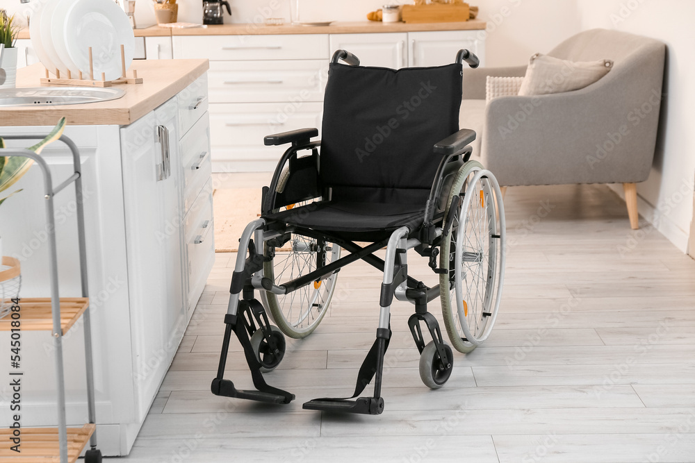 Modern empty wheelchair in kitchen Modern empty wheelchair in kitchen