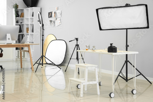 Interior of modern studio with photographer's workplace and equipment