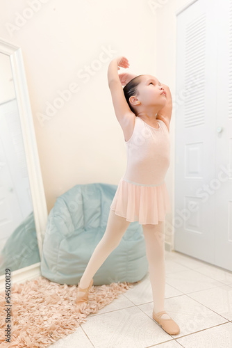 Rehearsal: little ballerina practicing ballet moves	