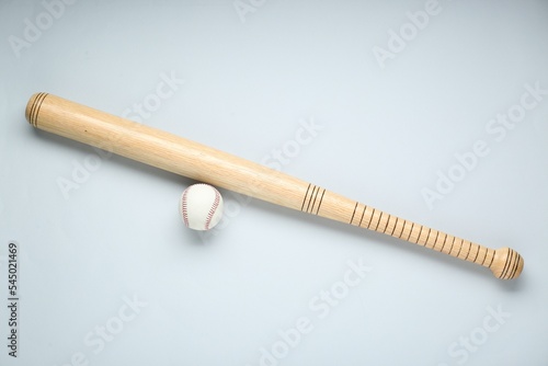 Wall Mural Wooden baseball bat and ball on light grey background, flat lay