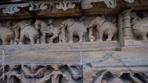 Woman Touch The Carved Elephant Artworks On Khajuraho Temple In Chhatarpur, Madhya Pradesh, India. - zoom out photo