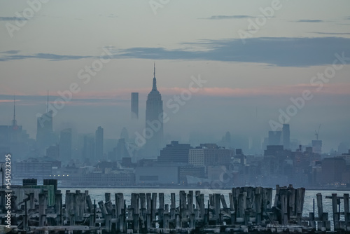 Jersey City, New Jersey: View across the Hudson River of the Empire State building shrouded in fog, from Liberty State Park.