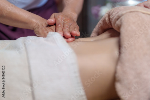 Professional masseur doing therapeutic massage. Woman enjoying massage  Young woman getting relaxing body massage beauty spa center body care, skin care, wellness, wellness, beauty treatment concept