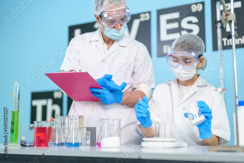Modern medical research laboratories Beautiful female scientist wearing protective goggles mixes chemicals in test tubes in laboratory biochemical samples, an advanced science laboratory for medicine.