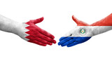 Handshake between Paraguay and Bahrain flags painted on hands, isolated transparent image.