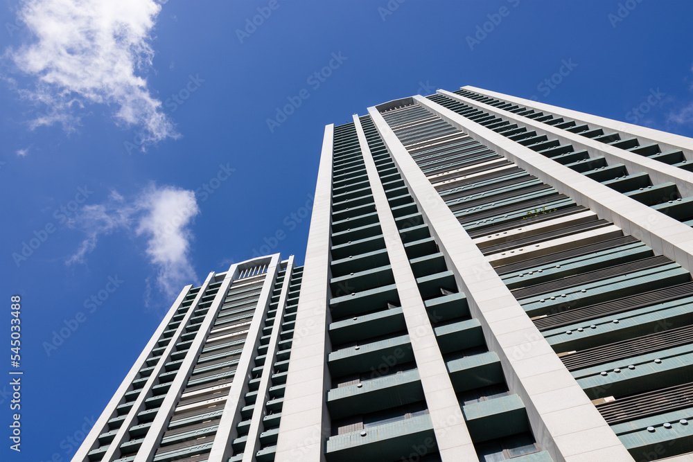 Low angle of apartment building over blue sky