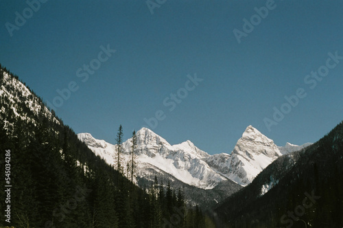 snow covered mountains in the canadian rockies, shot on 35mm film on a vintage analog camera