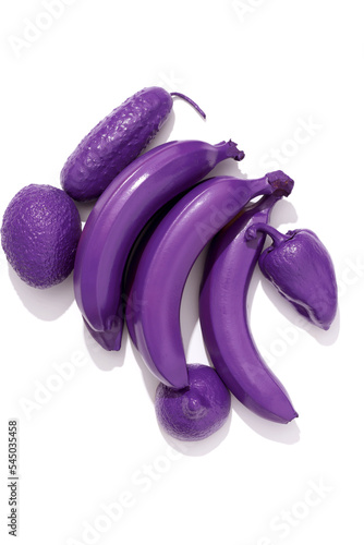 Concept ecology, fruits with nitrates, environmental pollution. Purple bananas, cucumber, avocado, pepper on white background, vertical (ID: 545035458)