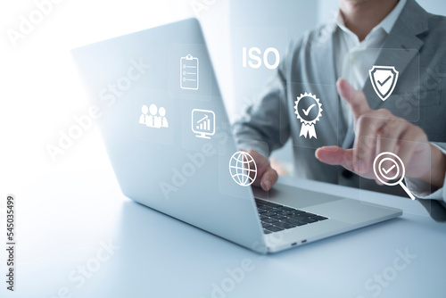 ISO Certification of standards quality control assurance business technology concept. Businessman using virtual screen iso certification icon to guarantee.