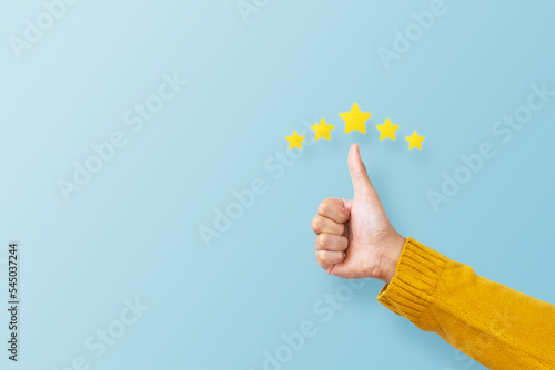 Leinwand Poster Man hand showing thumb and giving a five star rating