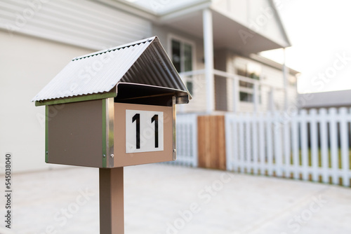 Urban mailbox with number 11 in front of new house