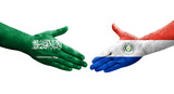 Handshake between Paraguay and Saudi Arabia flags painted on hands, isolated transparent image.