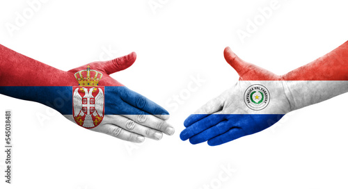 Handshake between Paraguay and Serbia flags painted on hands  isolated transparent image.