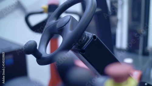 Engine compartment, steering wheel and control levers of the new modern powerful forklift. Shot in motion. Closeup. Follow focus. Shallow depth of field