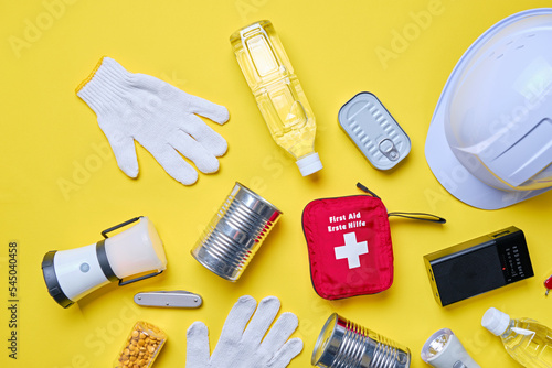 Disaster preparedness kit on yellow background.	