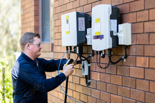 Electrician installing solar power connection to house