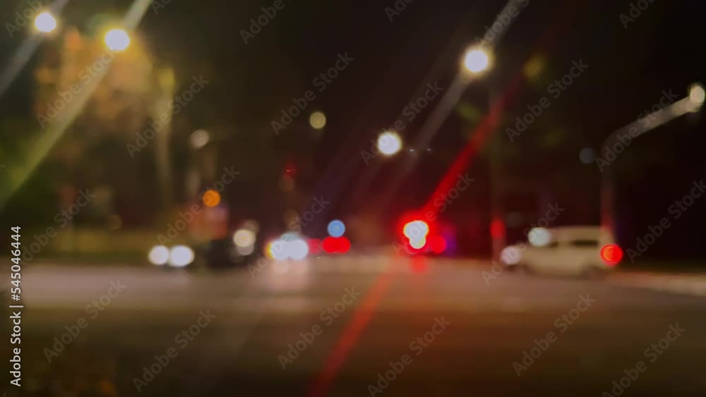 Police or ambulance car flashing lights, traffic accident, city street in soft focus Police or ambulance car flashing lights, traffic accident, city street in soft focus