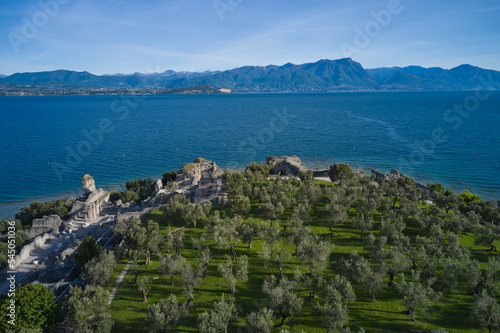 Aerial view of the Grotte di Catullo ruins of a large Roman villa on the peninsula. Olive grove and archaeological museum. The grottoes at the very peak of the Sirmione peninsula. Lake Garda, Italy.