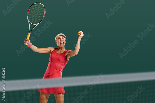 Happy female tennis player celebrating victory on professional court
