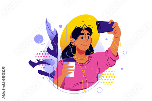 Smiling woman holding cup of coffee and taking selfie