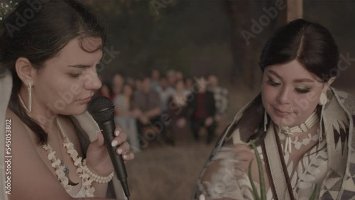 Two women saying their vows to each other at a two spirit wedding, Two-spiritedness in Native American tradition. photo