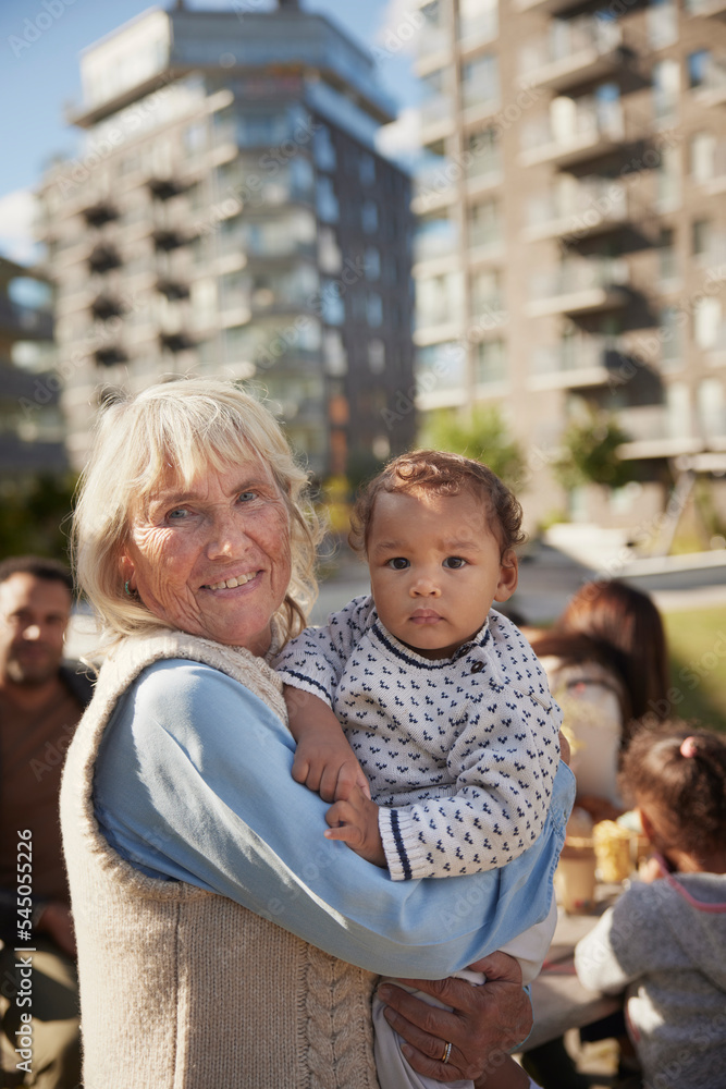 Smiling grandmother holding baby Smiling grandmother holding baby