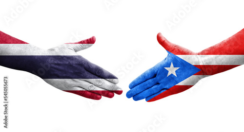 Handshake between Puerto Rico and Thailand flags painted on hands, isolated transparent image.