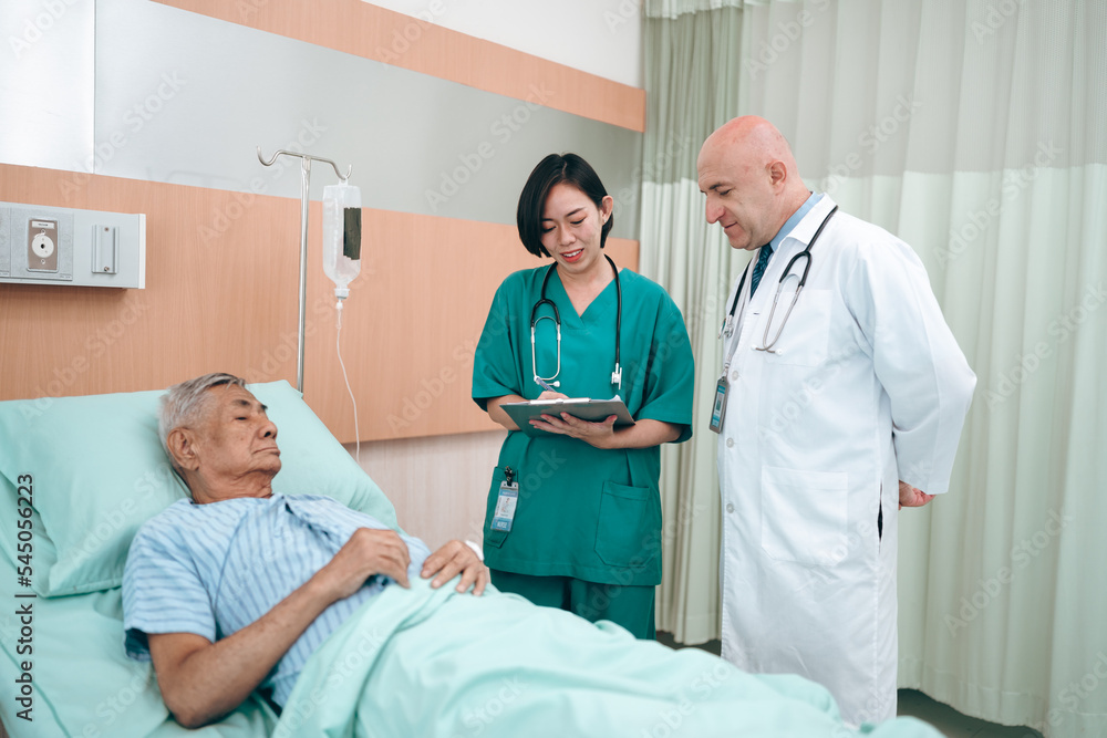 Fototapeta premium professional doctor standing by explain the treatment information via male elderly patient lying in bed in private hospital sickroom. The treatment program is suitable for people to socialize elderly