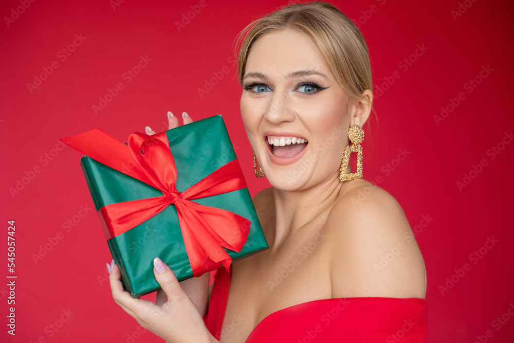 Surprised, grateful, elegant blond woman laughing with open mouth and look at camera, receive green and red present box Surprised, grateful, elegant blond woman laughing with open mouth and look at camera, receive green and red present box