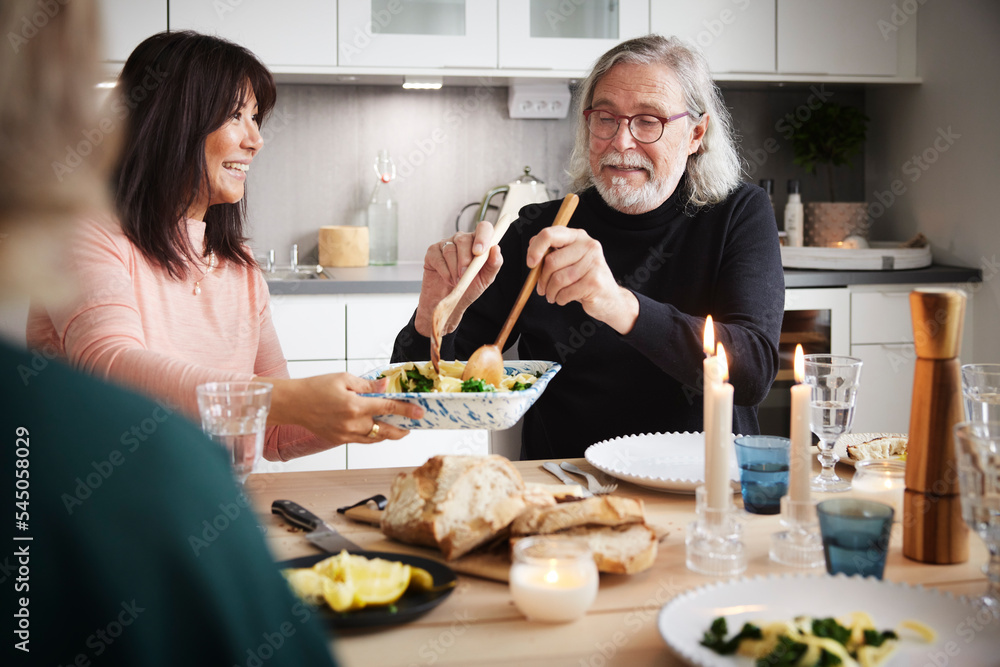 Family eating dinner at home together Family eating dinner at home together