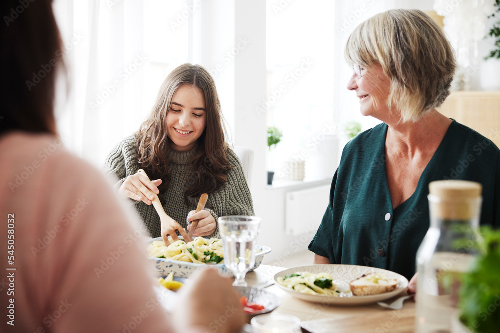 Family eating dinner at home together Family eating dinner at home together