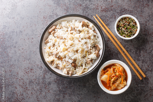 Easy and delicious Korean soybean sprout rice Kongnamul Bap with yummy seasoned soy sauce and kimchi closeup on the table. Horizontal top view from above