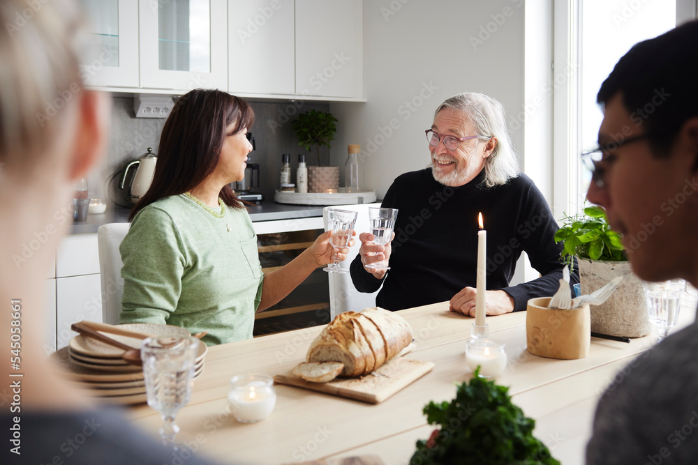 Family sitting at table and having drinks Family sitting at table and having drinks