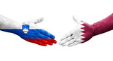 Handshake between Qatar and Slovenia flags painted on hands, isolated transparent image.