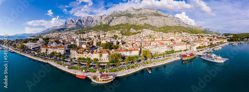 Town of Breal beach and Biokovo mountain aerial panoramic view, Makarska riviera in Dalmatia, Croatia