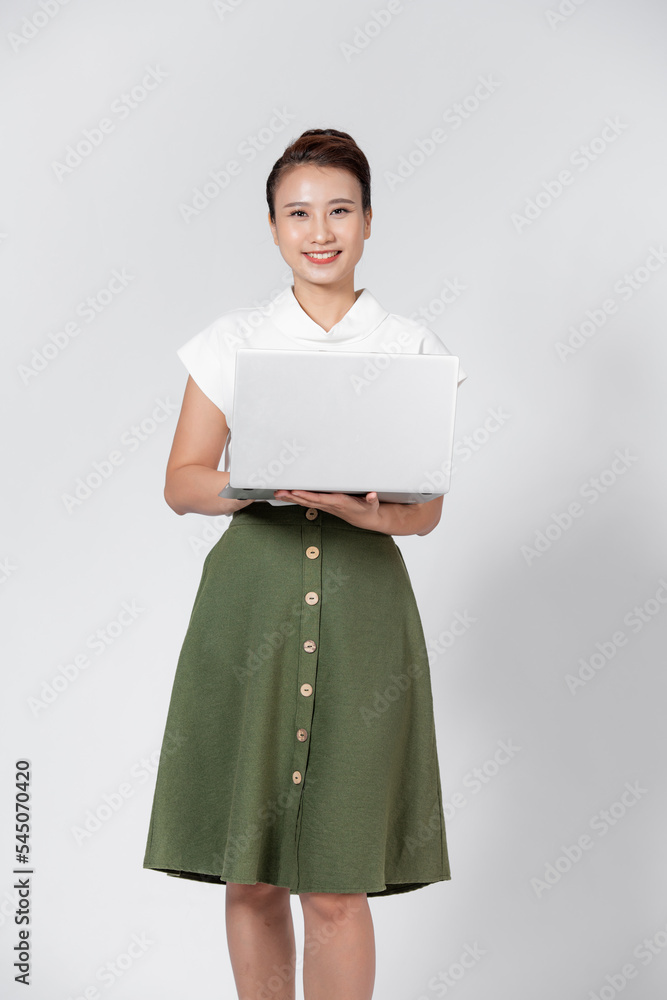 Portrait of happy young asian girl using laptop computer isolated over white background Portrait of happy young asian girl using laptop computer isolated over white background