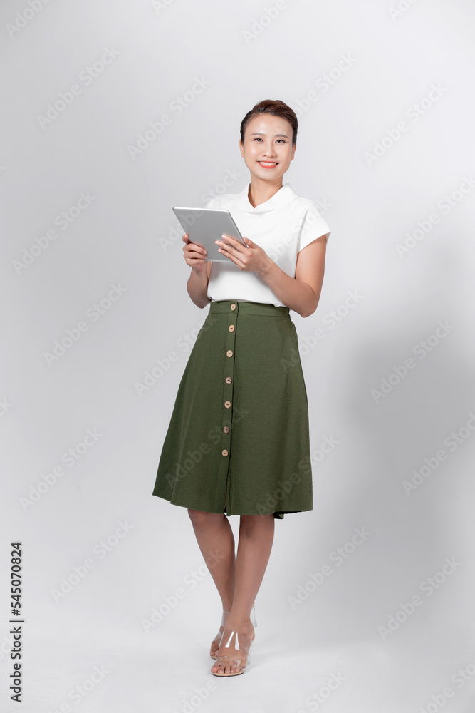 Portrait of young asian woman in casual wear holdng clipboard, smiling and looking at camera Portrait of young asian woman in casual wear holdng clipboard, smiling and looking at camera