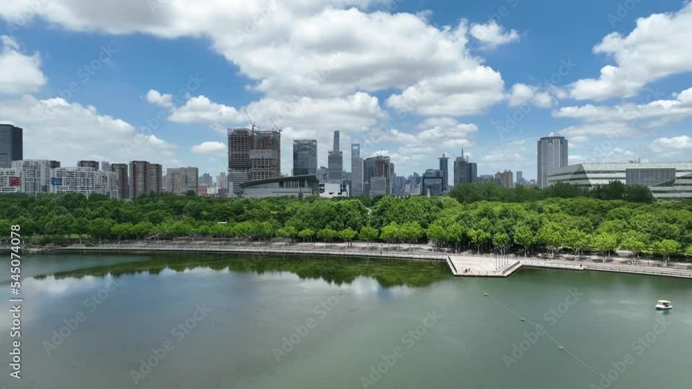 Park and the city skyline . Drone aerial view. Century park in Shanghai China. The city skyline in the background. Environment, nature, cityscape concept b-roll footage. Park and the city skyline . Drone aerial view. Century park in Shanghai China. The city skyline in the background. Environment, nature, cityscape concept b-roll footage.