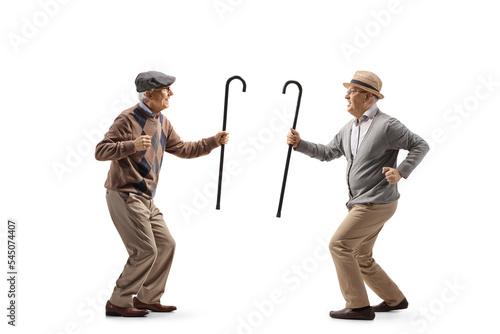 Full length profile shot of two happy elderly men dancing