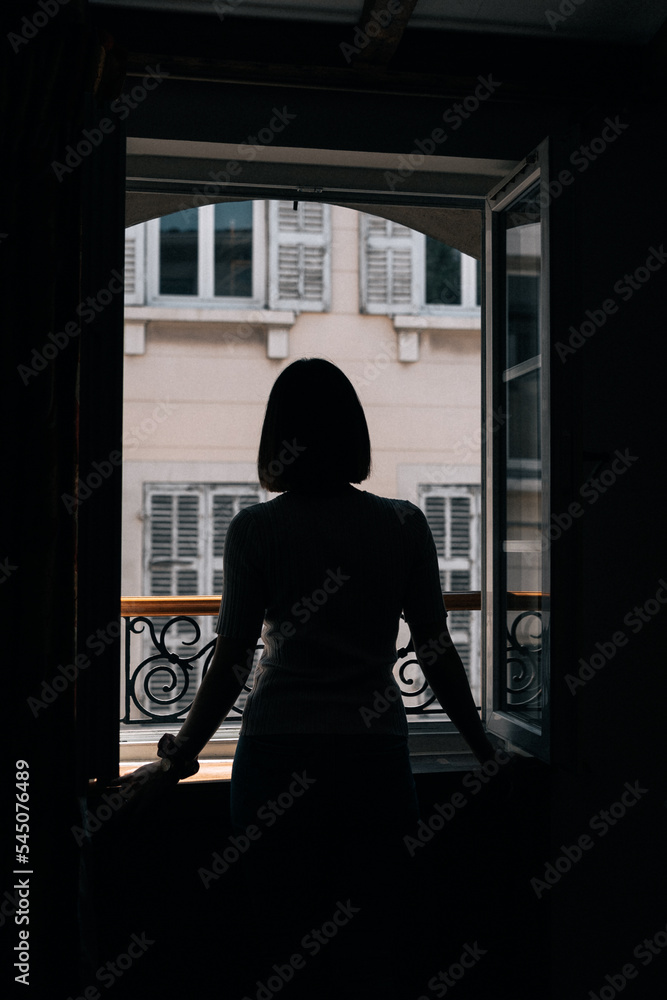 silhouette of a person in a window