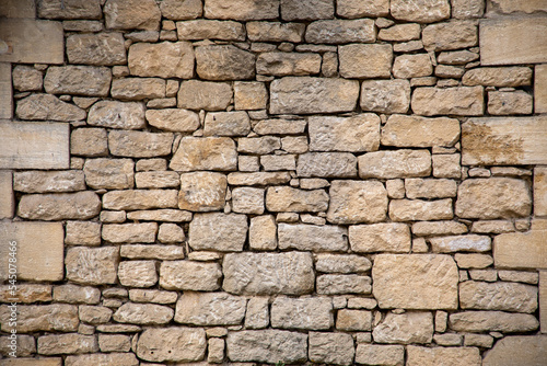 Stone facade restored wall assembled with pebbles of different sizes
