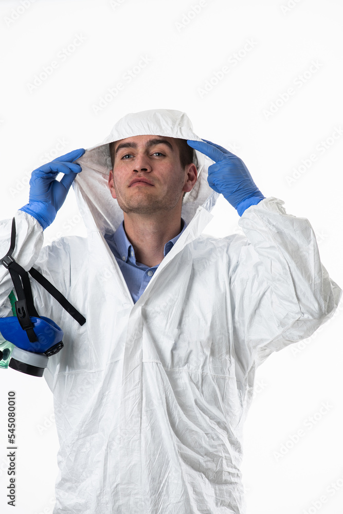 Doctor wearing protective biological suit and mask due to coronavirus 2019-nCoV global pandemic warning and danger background against white background. Doctor wearing protective biological suit and mask due to coronavirus 2019-nCoV global pandemic warning and danger background against white background.