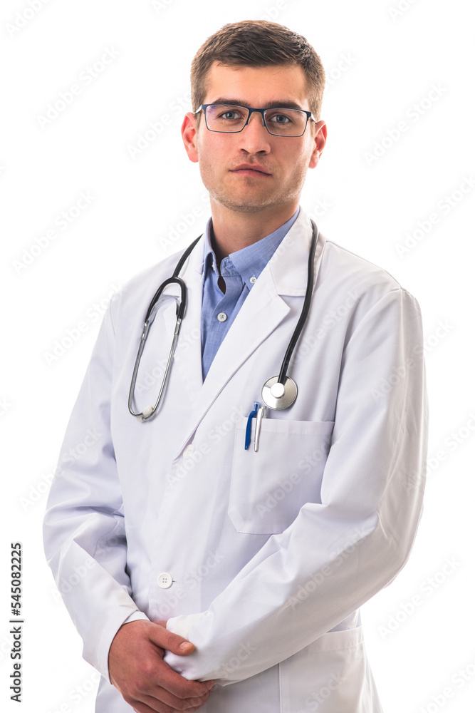Portrait of hero in white coat. Cheerful smiling young doctor with stethoscope in medical hospital standing against white background. Coronavirus covid-19 danger alert Portrait of hero in white coat. Cheerful smiling young doctor with stethoscope in medical hospital standing against white background. Coronavirus covid-19 danger alert