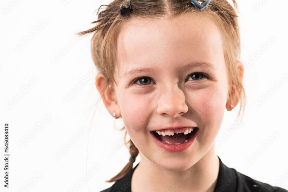 Portrait of a little girl on a white background with healthy, developing teeth Portrait of a little girl on a white background with healthy, developing teeth