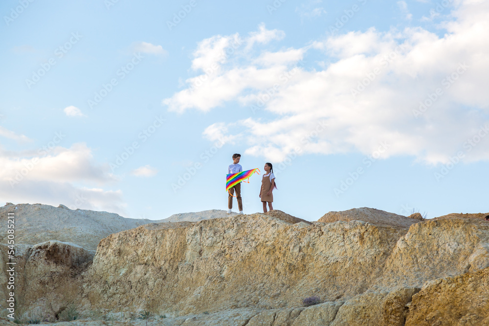 Brother and sister are going to fly kite chatting sweetly. Brother and sister are going to fly kite chatting sweetly.