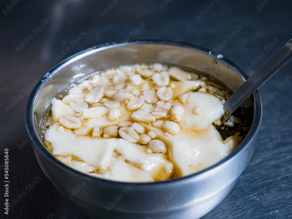 tofu pudding , soybean pudding with peanuts in bowl tofu pudding , soybean pudding with peanuts in bowl