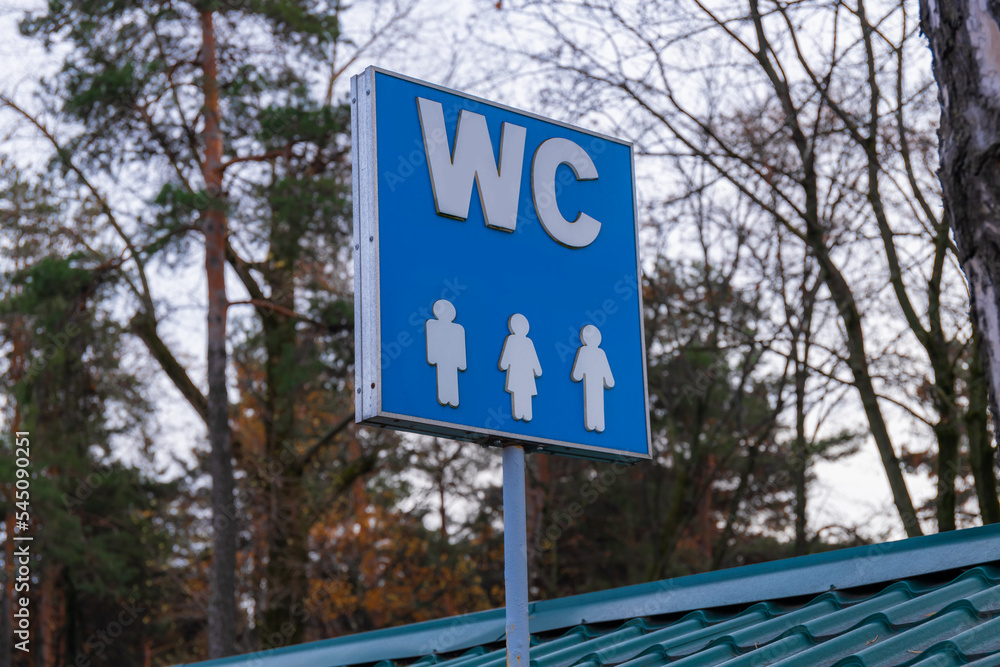 toilet signs he, she, they. blue sign on iron stick indicating the ...