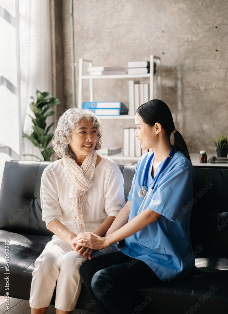 Medical doctor holing senior patient's hands and comforting her at home.. Medical doctor holing senior patient's hands and comforting her at home..