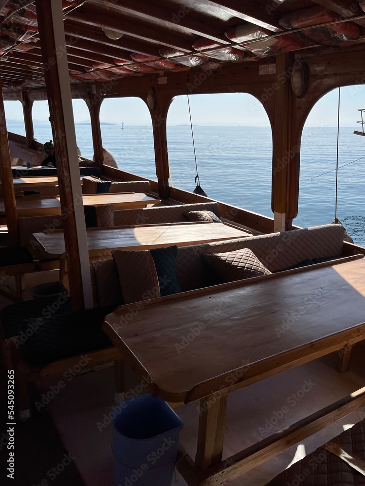 Fototapeta premium boat interior, wooden restaurant with sea view 